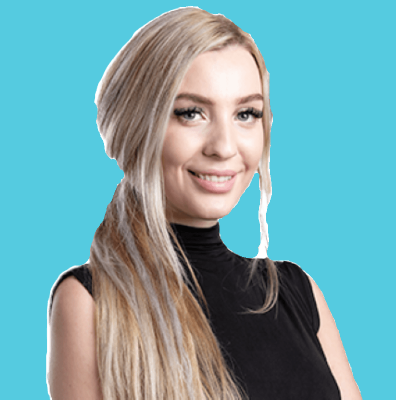 Portrait of a blonde smiling female smiling with a pale blue background,