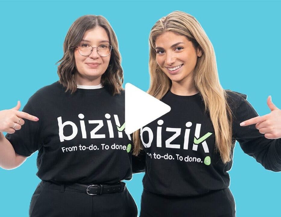 Two smiling females wearing matching black t-shirt that say Bizik.