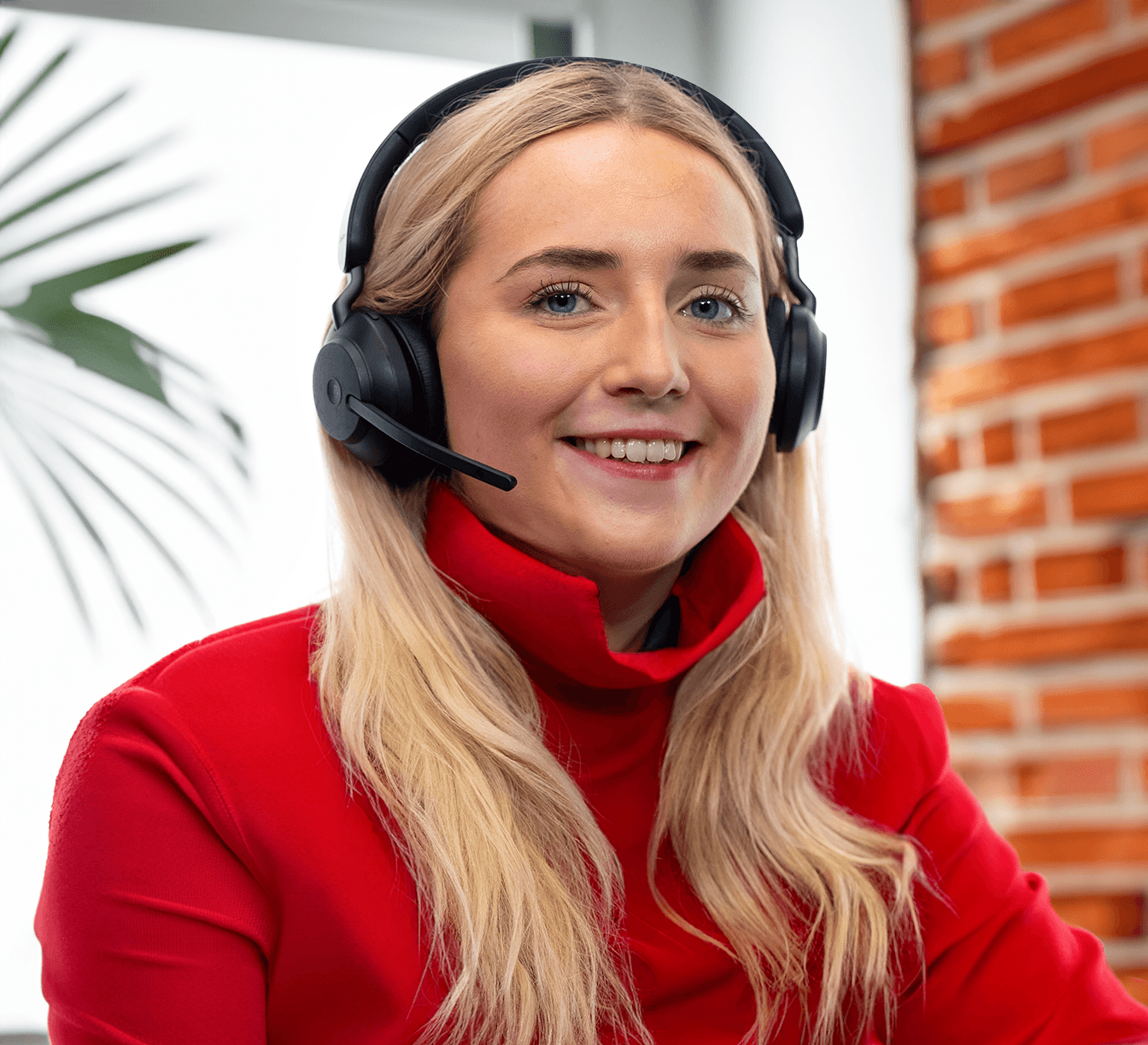 Smiling blonde female receptionist with a headset.