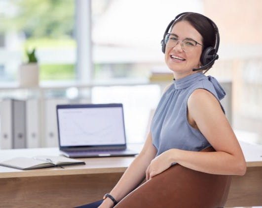 Smiling brunette female receptionist.