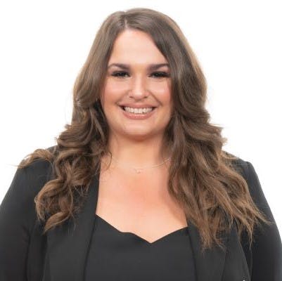 Portrait of smiling brunette female wearing a black top.