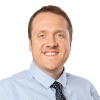 Portrait of smiling brunette caucasian male wearing a shirt and tie.