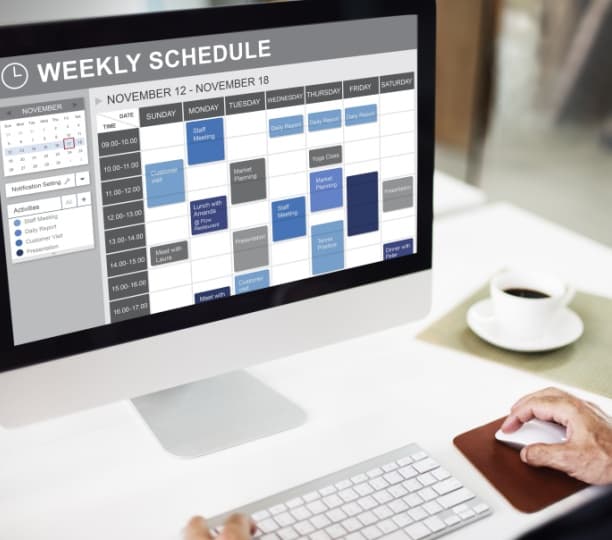 A computer screen displaying a weekly schedule, highlighting online scheduling and call answering service features