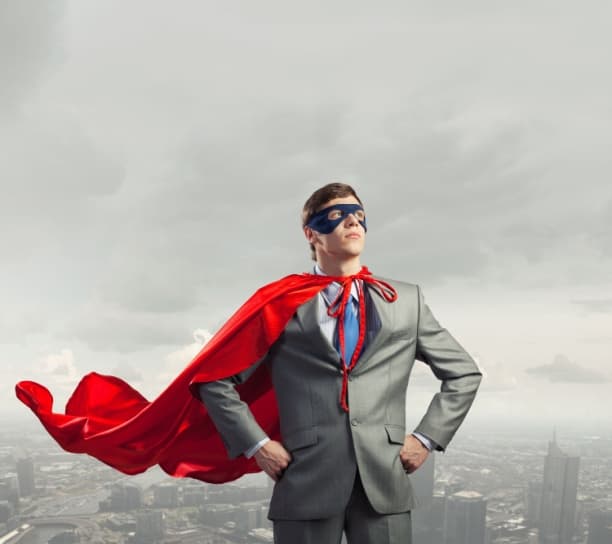 Young man in superhero costume and business suit, representing customer service excellence.