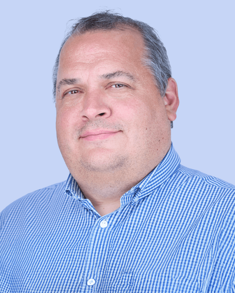 Smiling male operations manager wearing a shirt.