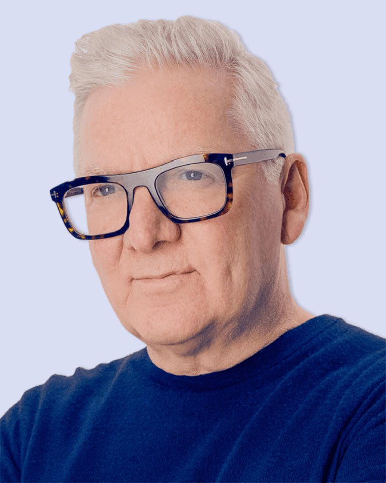 Portrait of Bizik CEO wearing black framed glasses smiling at the camera